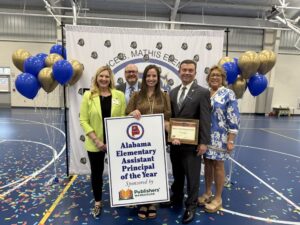 Erica Cruthirds recognized as Alabama Elementary Assistant Principal of the Year at Florence B. Mathis Elementary School, standing with colleagues and holding the award certificate.