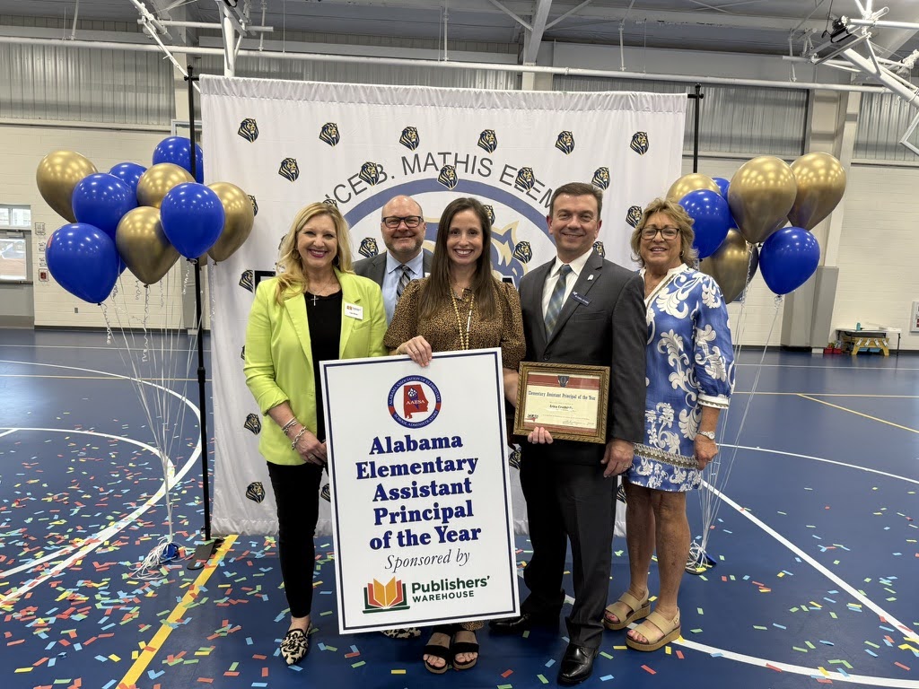 Erica Cruthirds recognized as Alabama Elementary Assistant Principal of the Year at Florence B. Mathis Elementary School, standing with colleagues and holding the award certificate.