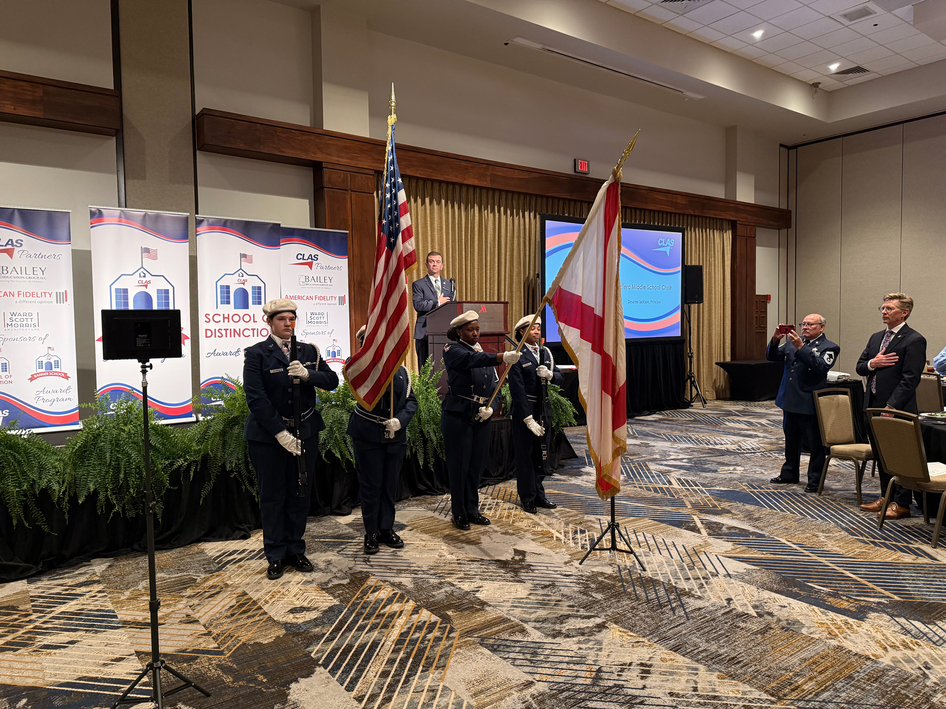 JROTC honor guard members in uniform posting the American and state flags at the CLAS Banner Schools Awards Luncheon ceremony