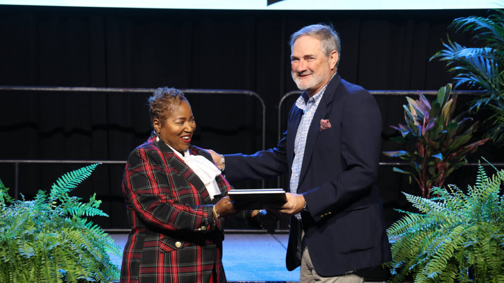 Dr. Regina Thompson presents Dr. Vic Wilson with the Dr. James A. Street Award on stage at the 2026 CLAS Convention.