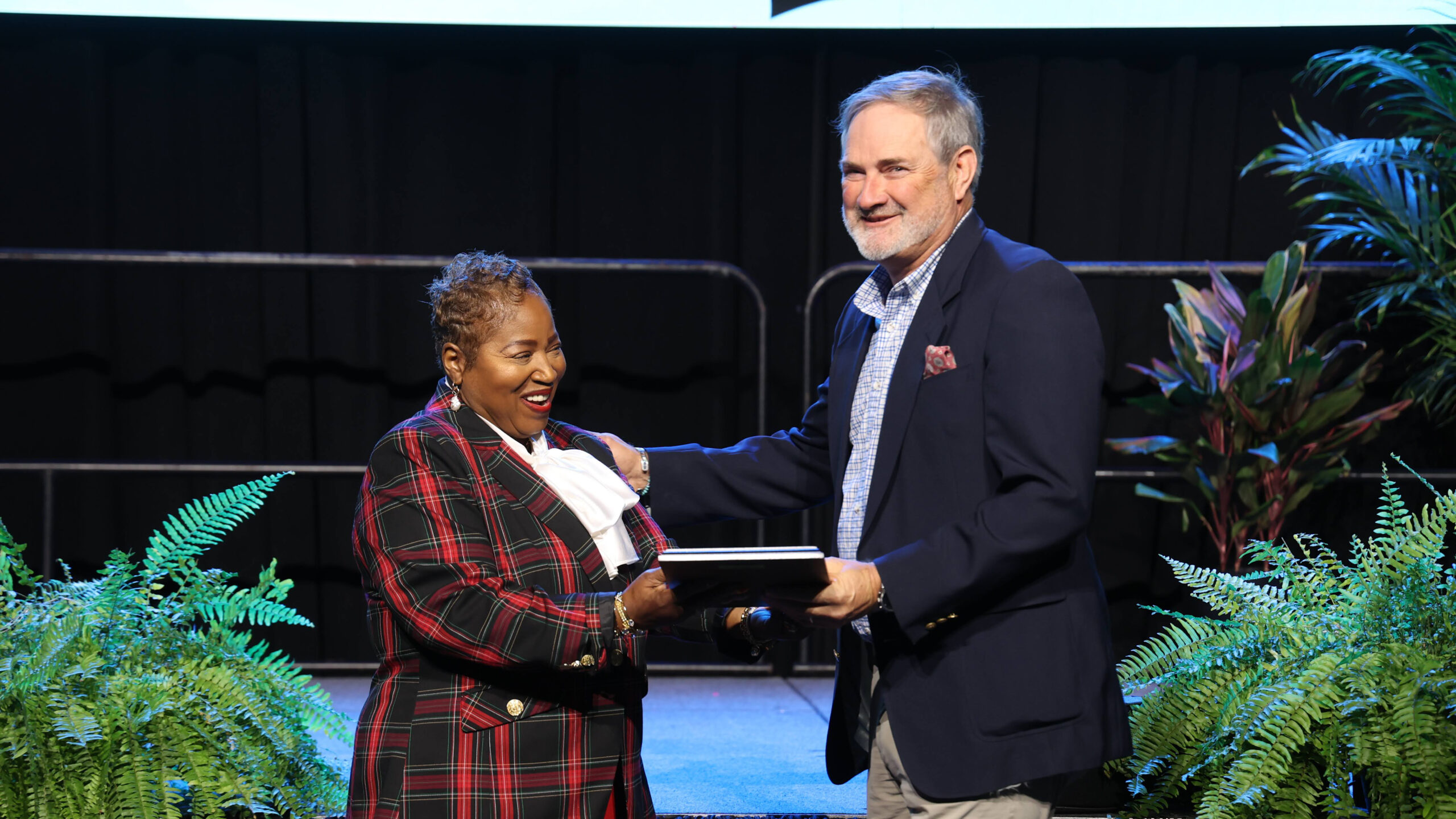 Dr. Regina Thompson presents Dr. Vic Wilson with the Dr. James A. Street Award on stage at the 2026 CLAS Convention.